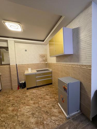 an empty kitchen with a sink and a cabinet at Suite BMB in Abidjan