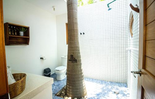 a bathroom with a shower with a column in it at Carpe Diem Casitas & Villas Mazunte in Mazunte