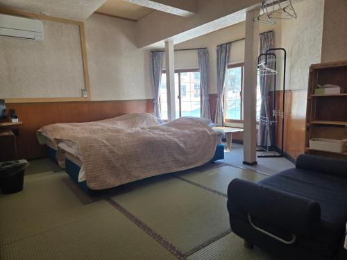 a hospital room with a bed and a mirror at Annex Aburaya in Iiyama