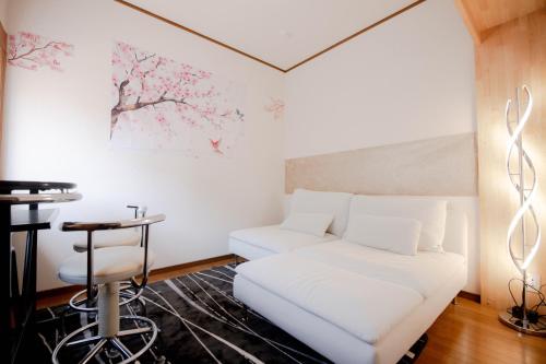 a living room with a white couch and a table at Ponpon Railway House in Kyoto