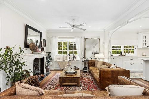a living room with a couch and a fireplace at Antara House by Coast Hosting in Matcham