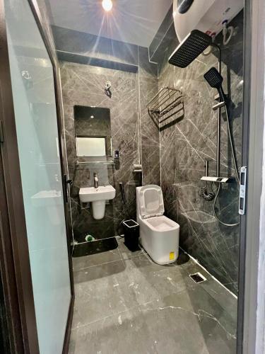 a bathroom with a sink and a toilet at Hanoi Backpacker Home in Hanoi