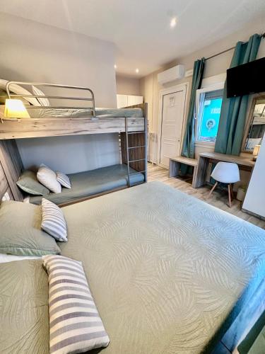 a bedroom with two bunk beds and a television at ΑVLI Sarti Studios & Apartments no 3 in Sarti