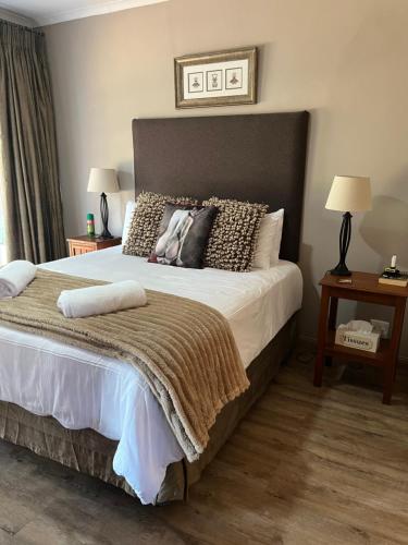 a bedroom with a large bed with pillows on it at Makiti Retreat in Polokwane