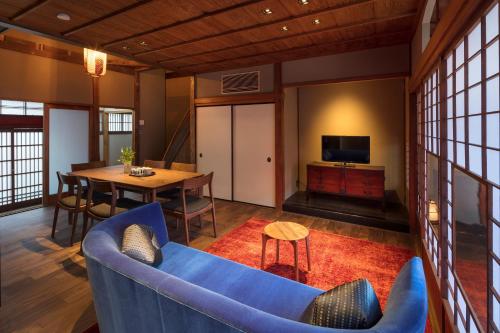 a living room with a blue couch and a table at Hikoso-machi Kin no Ma in Kanazawa