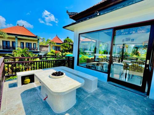 a patio with a bench on a balcony at Villa Danu Kintamani in Kintamani