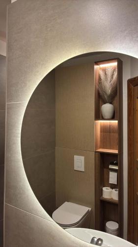 a bathroom with a sink and a toilet and a mirror at Grande Vendégház in Tata