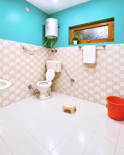 a bathroom with a toilet and a sink at Adarsh homestay - 1BHK in Manāli