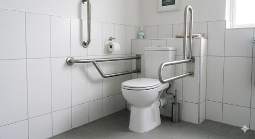 a bathroom with a white toilet in a stall at Hotel Palace inn Agra in Tājganj