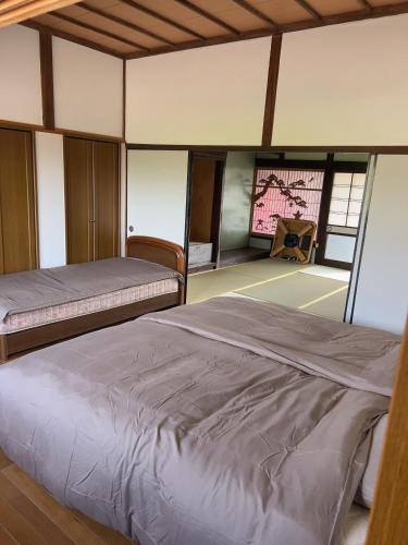 a bedroom with two beds and a window at Stonehouse2 in Usa