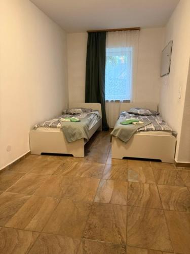 two twin beds in a room with a wooden floor at Thomas in Judenburg