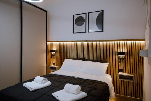 a bedroom with a bed with two towels on it at FOS Kastoria in Kastoria
