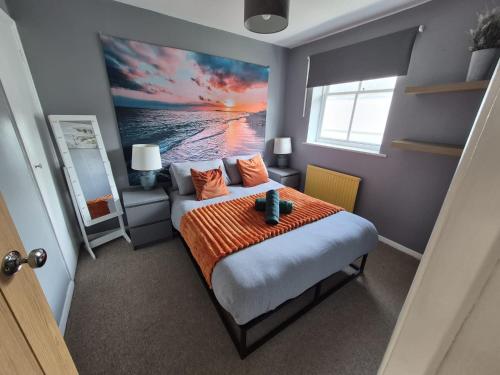 a bedroom with a bed and a painting of the ocean at Brighton Central Home with free parking in Brighton & Hove