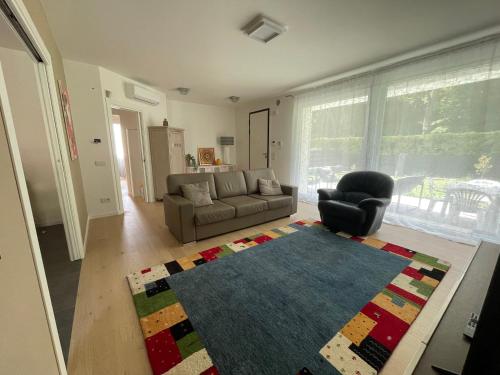 a living room with a couch and a chair at Casa Valeria in Abano Terme