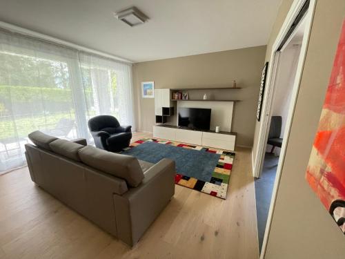 a living room with a couch and a chair at Casa Valeria in Abano Terme