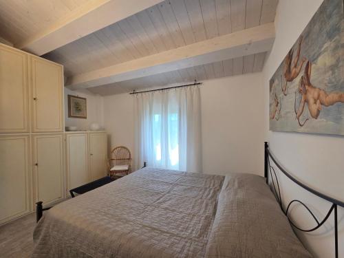 a bedroom with a bed in a room with a window at Locazione del cavaliere in Fano