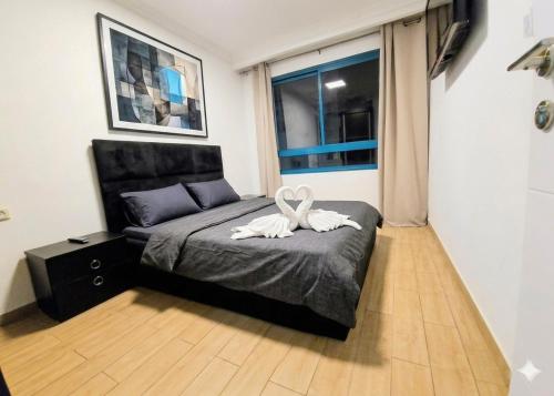 a bedroom with a bed with a white towel on it at טבריה 315 in Tiberias