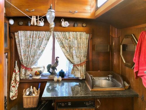 a kitchen with a sink and a window at Molly the Showman's Wagon in Hailsham
