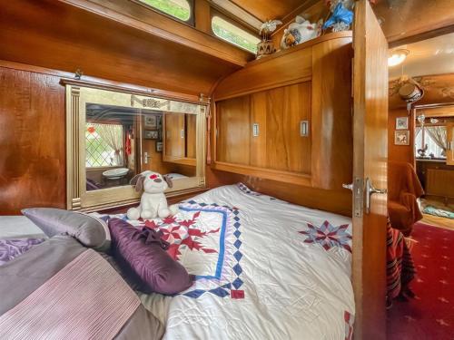 a bedroom with a bed in a boat at Molly the Showman's Wagon in Hailsham