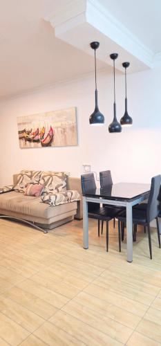 a living room with a table and a couch at טבריה 315 in Tiberias