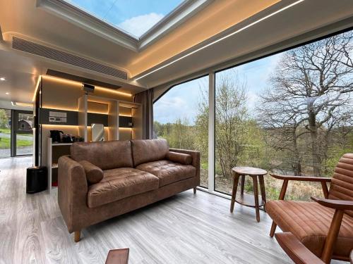 a living room with a couch and a large window at Vessel 2 - Ukc9442 in Glasgow