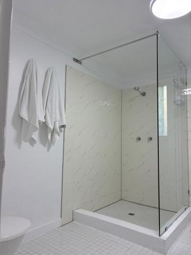 a bathroom with a shower with a glass door at Flip flops in Horseshoe Bay