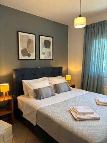a bedroom with a large bed with two pillows at Noēma House I in Chóra