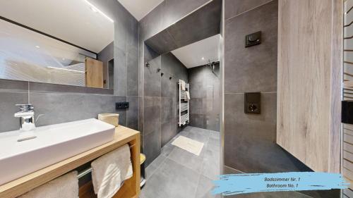 a bathroom with a sink and a mirror at Haus Bergkristall in Sankt Anton am Arlberg