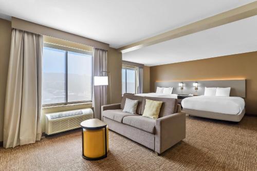 a large hotel room with a bed and a couch at Comfort Suites El Paso West in Montoya