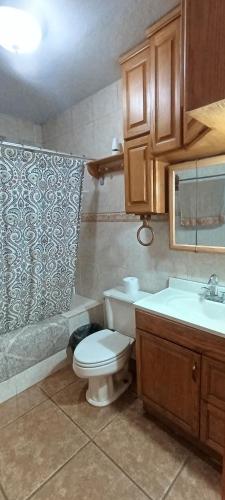 a bathroom with a toilet and a sink at Casa Lagunita in Ensenada