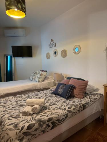 a bed with pillows on it in a room at Evens-Goretti House in Mairena del Aljarafe