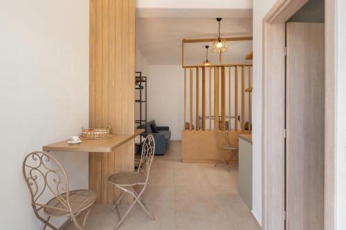 a living room with a table and two chairs at Marilia Studios in Livadakia