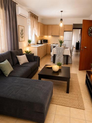 a living room with a couch and a table at Keramoti Luxury Apartments in Keramoti