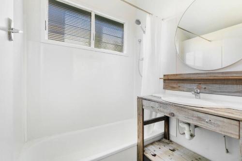 a bathroom with a mirror and a sink at 30A Urangan Beach Cottage (Front Property) in Urangan
