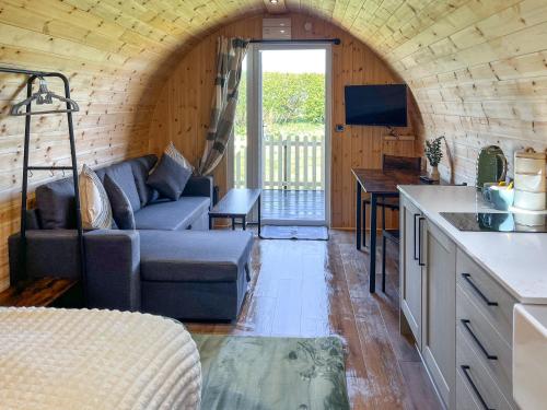 a kitchen and living room with a couch and a table at Oak - Uk51863 in Reighton