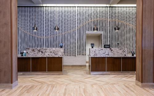 a lobby with two sinks and a large wall at Embassy Suites by Hilton Minneapolis Bloomington Edina in Bloomington