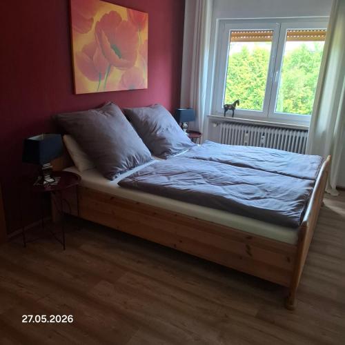 a bed sitting in a bedroom with a window at Casa Calali haustierfreundlich u barrierefrei in Bad Endbach