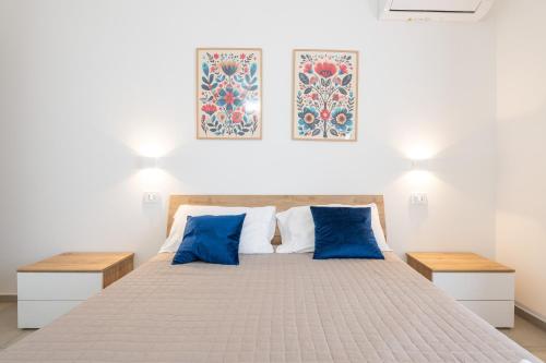 a bedroom with a large bed with blue pillows at Sa concia in Teulada
