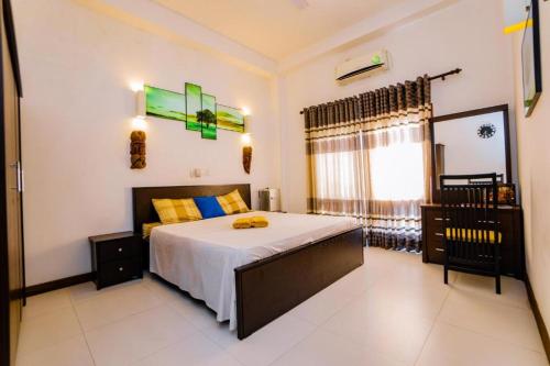 a bedroom with a large bed and a window at White House 101 in Galle