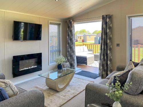a living room with a couch and a fireplace at The Valerie Jean in Bridlington