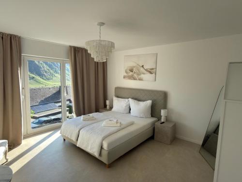 a bedroom with a bed and a large window at Gästehaus Paulina in Cochem