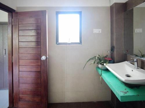 a bathroom with a sink and a window at White House 101 in Galle