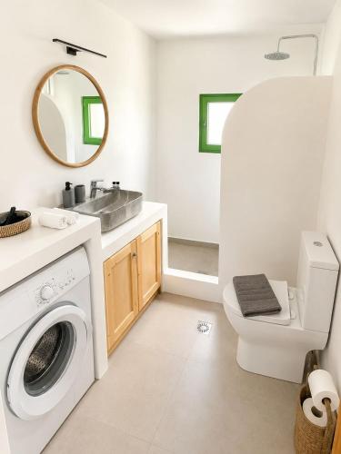 a bathroom with a washing machine and a sink at Villa Elli in Halki