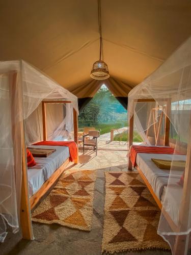 two beds in a tent with a view at Emaamara camp in Narok