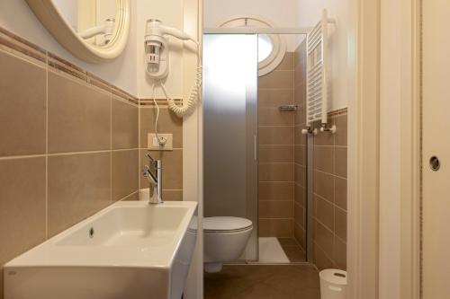a bathroom with a sink and a toilet at Appartamento Il Nespolo in Pontedera
