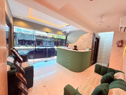 two people sitting at a bar in a restaurant at Hotel Adkar Residency Borivali West in Mumbai
