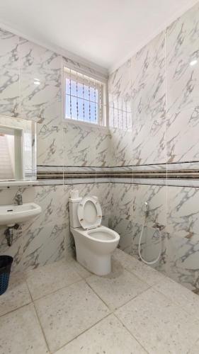 a bathroom with a toilet and a sink at Villa Dalia Puncak N5-10 in Cikundul