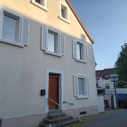 a white building with a door and a stairs at Ethical Choice Residence in Kaiserslautern
