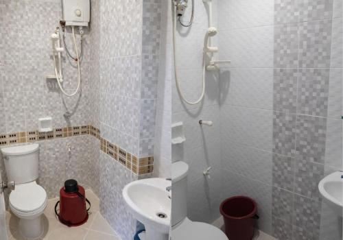 a bathroom with a shower and a toilet and a sink at Kyleville Resort by Hiverooms in Dalaguete