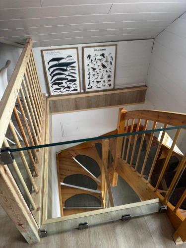 a spiral staircase in a room with wood at Bjarmaland in Vestmannaeyjar